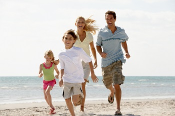 family running on the beach